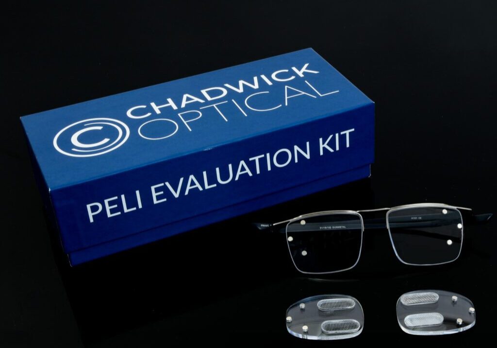 Chadwick Optical Peli Evaluation Kit box with glasses and specialized prism lenses, displayed on a black surface.